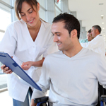 Man in wheelchair talking to physician