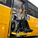 Woman exiting bus in wheelchair